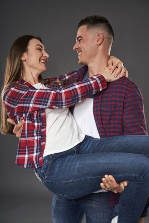 Young caucasian couple posing against gray backgroundの写真素材