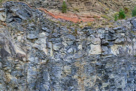 Various rock formation in geological layers in an abandoned quarry