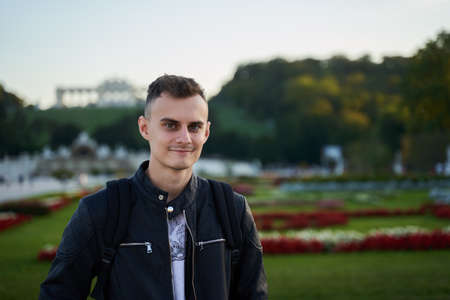 Selective focus portrait of a handsome young man in urban environment