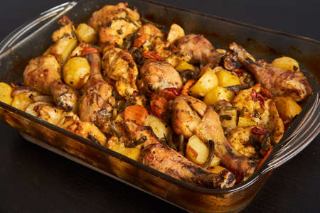 Closeup of grilled chicken drumsticks with potato chipsの写真素材