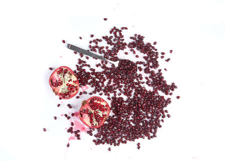 Fresh pomegranate fruits and juicy seeds isolated on white background