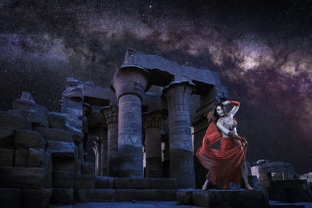 Oriental dancer performing under Milky Way at a temple ruins