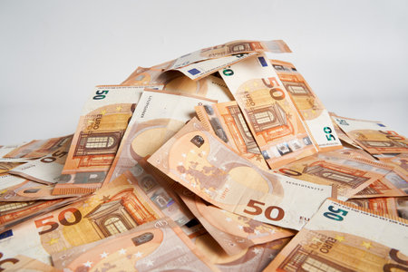 Euro bills on white background, symbol of wealthの写真素材