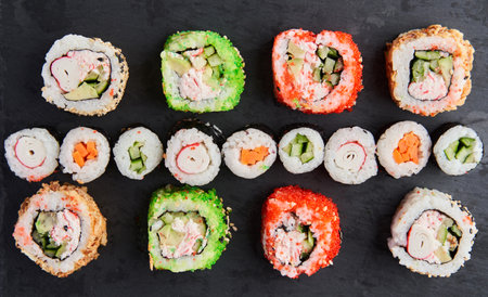 Flat lay shot of a variety of sushi on a wooden boardの写真素材