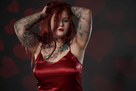 Redhead plus size woman with tattoos in lingerie, studio shotの写真素材