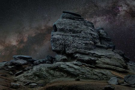 Romanian Sphinx at night, geological phenomenon formed through erosion, with Milky Way in the backgroundの写真素材