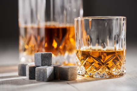 Whiskey on the rocks on a wooden boardの写真素材