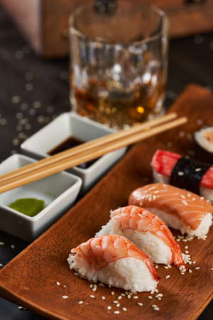 Fresh sushi assortment served on rustic wooden plateの写真素材