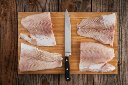 Closeup of fresh raw zander fillets on a wooden boardの写真素材