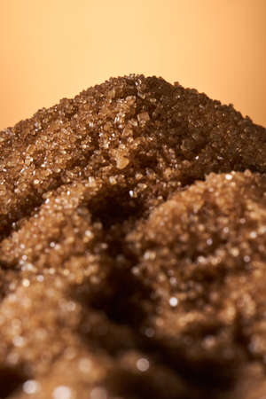 Hills of brown cane sugar, with sunset behind