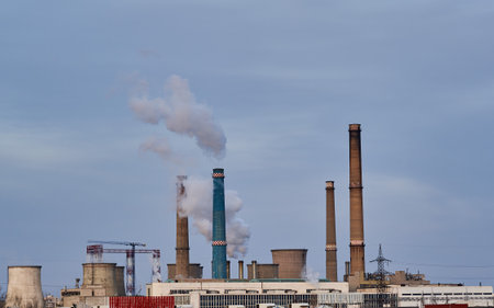 Industrial pollution concept with funnels and thick white smoke rising up in the atmosphereのeditorial素材