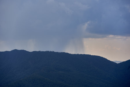 Landscape with curtains of torrential heavy rain in the mountains