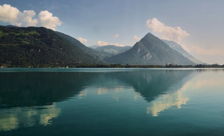 Landscape with a big lake and mountains covered in forestsの写真素材