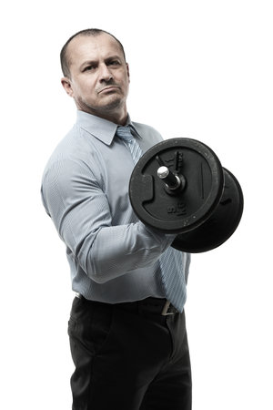 Strong businessman lifting a heavy dumbbell, isolated on white backgroundの写真素材