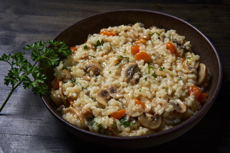 Thai recipe of boiled and fried rice with mushrooms and herbs and veggies in a rustick bowlの写真素材