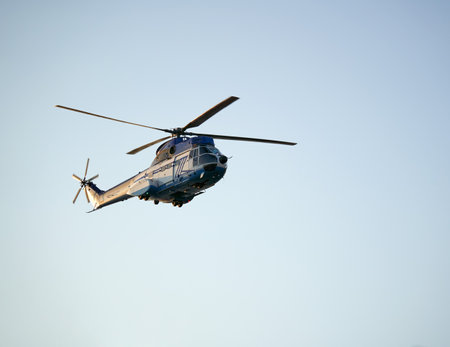 Stop motion of a helicopter in flight against clear blue sky