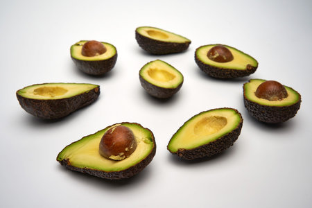 Closeup of fresh avocado sliced isolated on white background