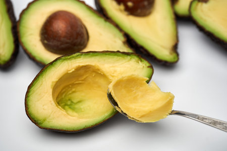 Closeup of fresh avocado sliced isolated on white backgroundの写真素材