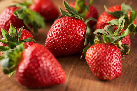 Juicy strawberries, freshly picked, on a rustic wooden boardの写真素材