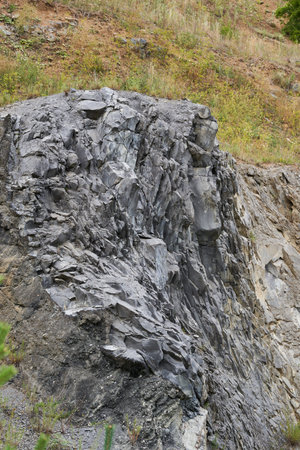 Various rock formations of basalt, sandstone, dross and others in layers in an abandoned quarry