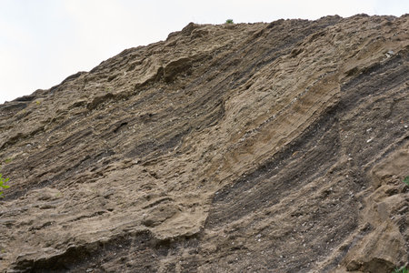 Various rock formations of basalt, sandstone, dross and others in layers in an abandoned quarry