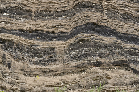 Various rock formations of basalt, sandstone, dross and others in layers in an abandoned quarryの写真素材