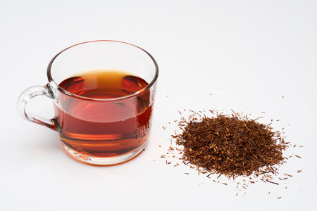 Closeup of a cup of South African Rooibos tea long cut, isolated on white backgroundの写真素材