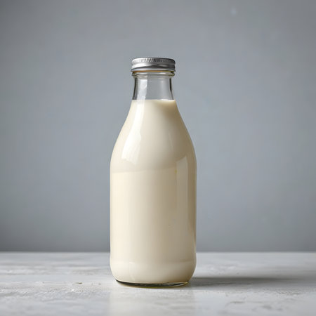 Bottle of milk on white wooden table, isolated on gray backgroundの素材