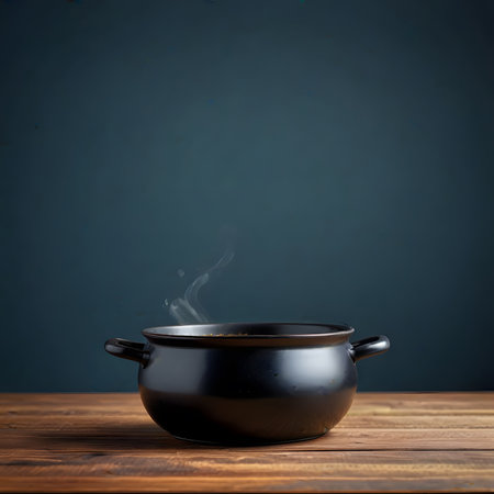 Black pot with boiling water on wooden table over dark blue background.の素材