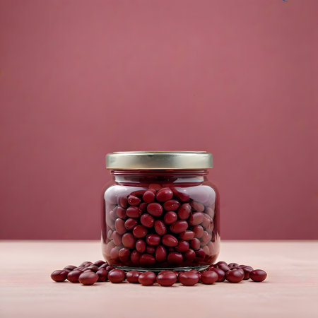 Red kidney beans in glass jar on pink background. Copy space.の素材