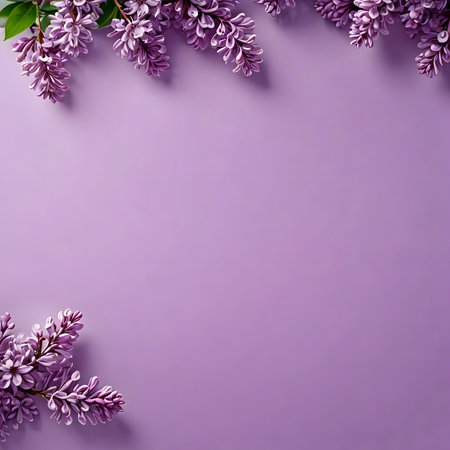 Lilac flowers on purple background. Top view with copy spaceの素材