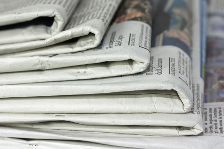 newspapers against plain background shot with very shallow depth of fieldの写真素材