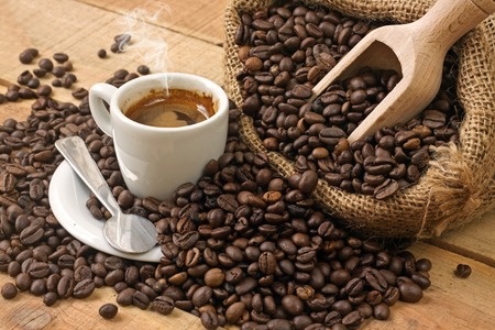 coffee cup and grains on wooden tableの写真素材