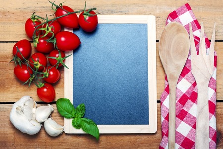 chalkboard menu on a wooden background with ingredientの写真素材