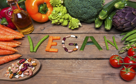 vegan word on wood background and vegetable - foodの写真素材