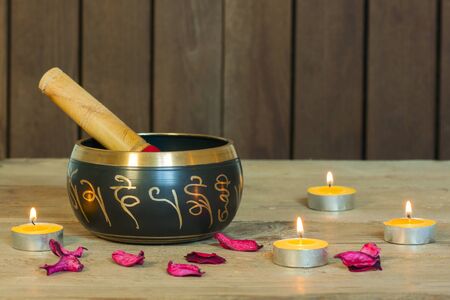 Studio shot of Tibetan singing bowls with burning candlesの写真素材