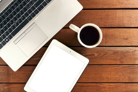 set of modern computer devices - laptop, tablet, notebook and  cup of tea - muck upの写真素材