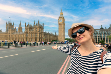 Holidays in the UK. young girl takes selfie picture with smartphone in London, UK.の写真素材