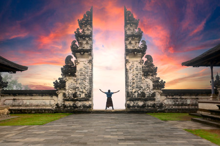 Traveler Standing at the Gates of Pura Lempuyang Temple aka Gates of Heaven Bali, Indonesiaの写真素材