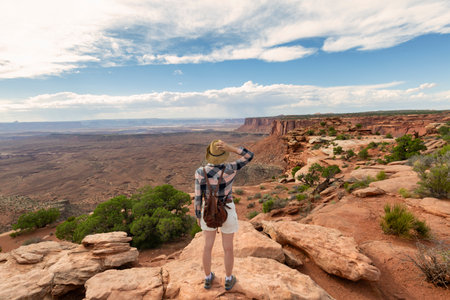 woman on hiking trip. tourist standing on top of the mountain, looking at beautiful mountains landscape'sの写真素材