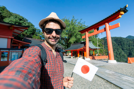 Handsome young tourist enjoying summer holiday in Japan - Traveling life style concept with smiling...