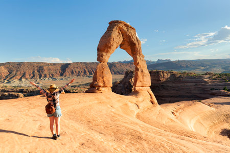Woman looking at the Delicate Arch in Arches National Park, United States