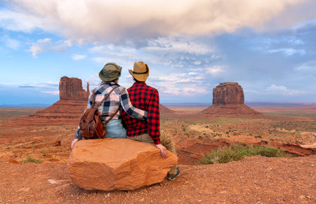 Young couple enjoying sunset view of Monument Valley National Park.の写真素材