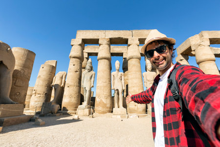 A selfie photo taken at the ancient ruins of the Karnak temple in Luxor, Egypt, showcasing the historic columns and statuesの写真素材