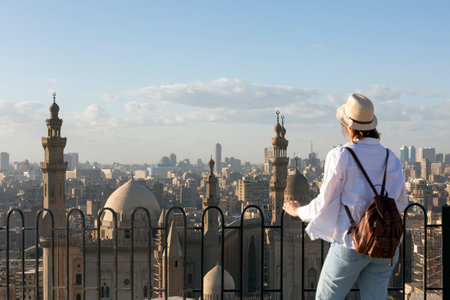 Young woman tourist looking at the Mosque and Madrasa of Sultan Hasan in Cairo, Egyptの写真素材
