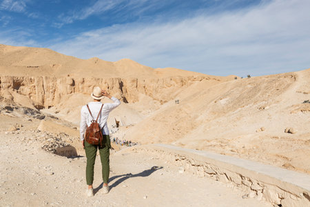 Woman tourist looking at the Valley of the Kings. The tombs of the pharaohs. Tutankhamun. Luxor. Egypt. Ancient architecture monument.の写真素材
