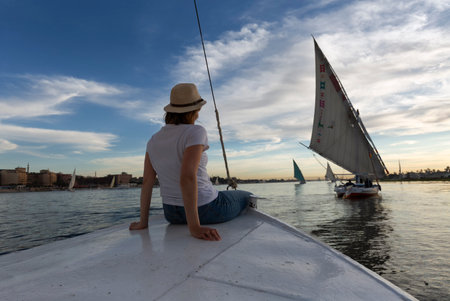Experience a felucca ride on the Nile River in Aswan with pharaonic sights and tourist joy. Enjoy a traditional felucca ride on the Nile.の写真素材