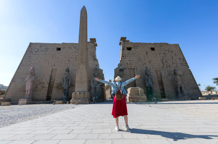 Woman tourist at Luxor Temple in a sunny day, Luxor, Egyptの写真素材