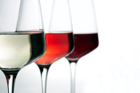 three wine glasses with wine on white backgroundの写真素材
