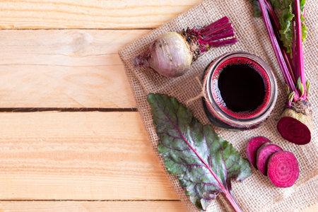 Freshly made beet juice on wood table. Space for textの写真素材